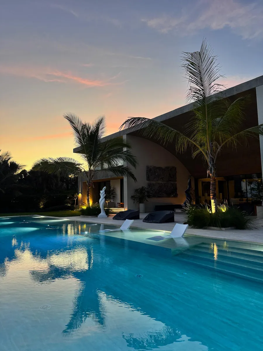 Arrecife residence with curved wood ceilings at dusk