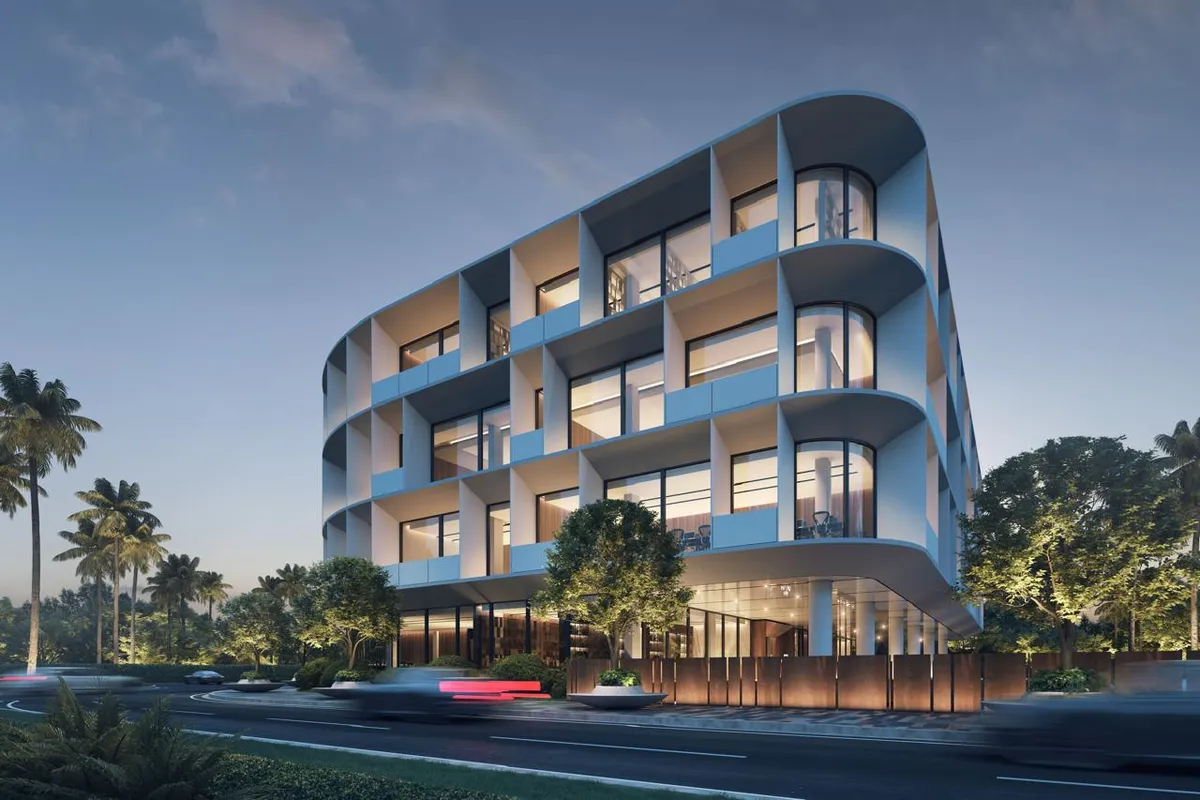 Architectural rendering of the Altum Business Center, a curved multi-story commercial building at dusk